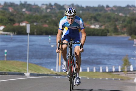 Cyclist cycling on road Stock Photo - Rights-Managed, Code: 858-03049514