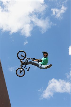 Man jumping with bicycle against cloudy sky Stock Photo - Rights-Managed, Code: 858-03049527