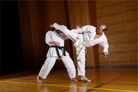 simsearch:858-03047596,k - Two karate contestants sparring,one directing kick at opponent Stock Photo - Rights-Managed, Code: 858-03049818