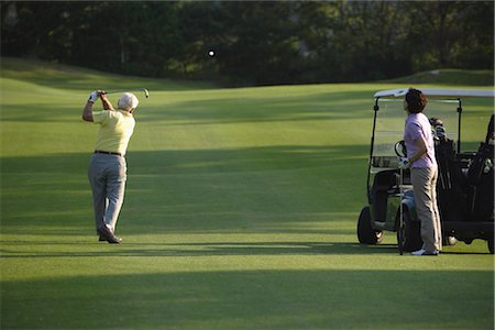 Couple playing golf at golf course Stock Photo - Rights-Managed, Code: 858-03049961