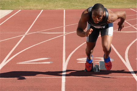 sprinters at starting blocks - Sprinter Leaving the Starting Blocks Stock Photo - Rights-Managed, Code: 858-03050082