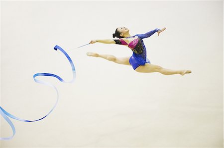 person mid air flip - Woman performing rhythmic gymnastics with ribbon Stock Photo - Rights-Managed, Code: 858-03050225