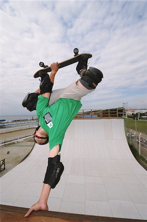 Asian man inverted while doing skateboarding Stock Photo - Rights-Managed, Code: 858-03799614