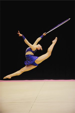 simsearch:614-08874274,k - Gymnast in mid-air performing with hoop Fotografie stock - Rights-Managed, Codice: 858-03799631