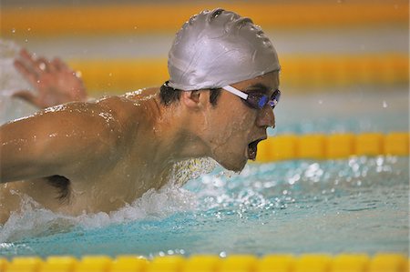 simsearch:600-05973054,k - Mid adult man swimming butterfly stroke Stock Photo - Rights-Managed, Code: 858-03799718