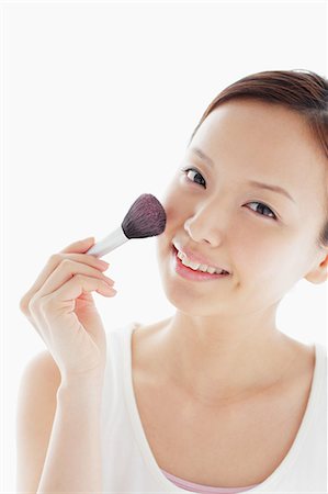 Japanese woman putting on make up Stock Photo - Rights-Managed, Code: 859-06404790