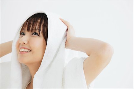 Portrait of a Japanese woman drying her hair Stock Photo - Rights-Managed, Code: 859-06404827