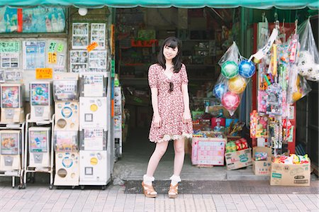 Japanese girl standing in front of an old candy shop Stock Photo - Rights-Managed, Code: 859-06404830