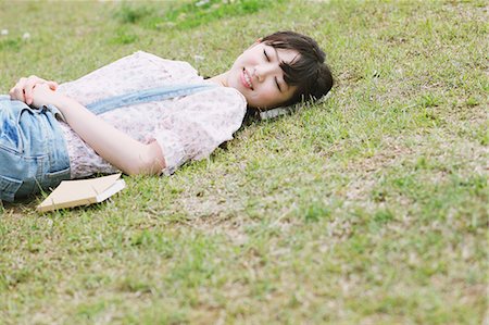 Japanese woman sleeping on the grass Stock Photo - Rights-Managed, Code: 859-06404845