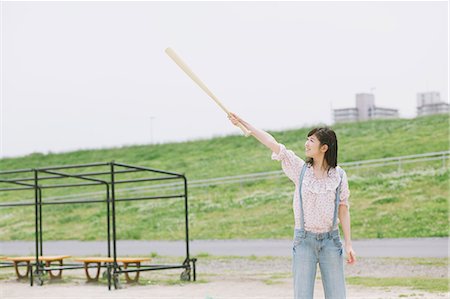 Japanese girl holding a baseball bat Stock Photo - Rights-Managed, Code: 859-06404841