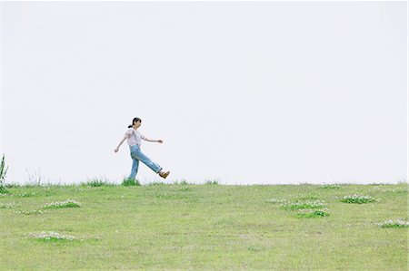 Japanese girl walking in the grass Stock Photo - Rights-Managed, Code: 859-06404843