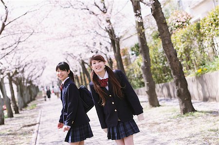 Japanese schoolgirls in their uniforms with cherry blossoms in the background Stock Photo - Rights-Managed, Code: 859-06404857