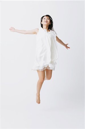 flying happy woman images - Femme asiatique dans une robe blanche sauter Photographie de stock - Rights-Managed, Code: 859-06404918