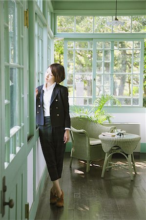 frame golden - Japanese woman in a black jacket standing by the window Stock Photo - Rights-Managed, Code: 859-06404935