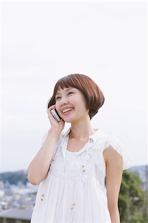 simsearch:859-06404932,k - Japanese woman with short hair in a white dress talking on the phone Stock Photo - Rights-Managed, Code: 859-06404964
