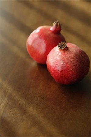 pomegranates not people not illustration - Two pomegranates on a wooden table Stock Photo - Rights-Managed, Code: 859-06469889