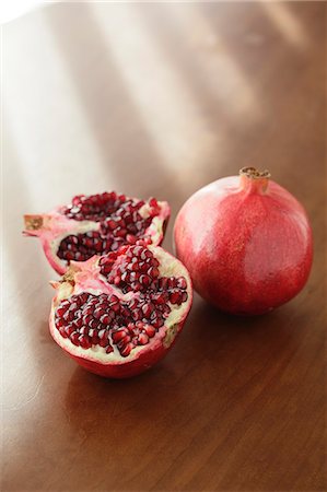 punica granatum - Two pomegranates on a wooden table Stock Photo - Rights-Managed, Code: 859-06469891