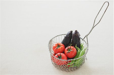 Vegetables in a metal basket on a table Stock Photo - Rights-Managed, Code: 859-06469971