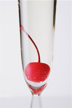 Glass of Champagne with a cherry in it Stock Photo - Rights-Managed, Code: 859-06470019