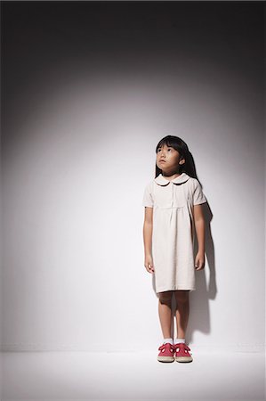 sad asian child - Girl in a white dress looking up Stock Photo - Rights-Managed, Code: 859-06537709