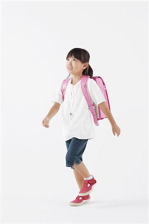 Girl carrying a school bag Foto de stock - Con derechos protegidos, Código: 859-06537719