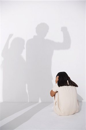 figures in shadows - Girl in a white dress sitting scared on the floor Stock Photo - Rights-Managed, Code: 859-06537711