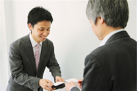 Businessmen exchanging business cards in the office Stock Photo - Rights-Managed, Code: 859-06537741
