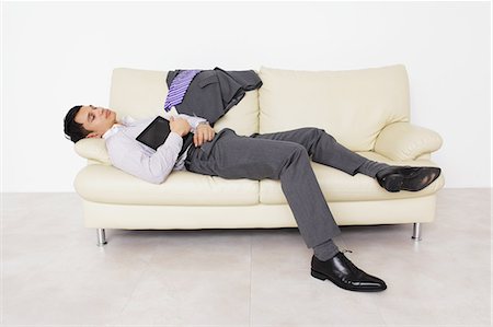 businessman sleeping on the sofa Stock Photo - Rights-Managed, Code: 859-06537822