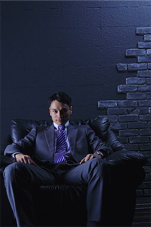 relaxing in lounge chair - Businessman sitting on a sofa Stock Photo - Rights-Managed, Code: 859-06537849