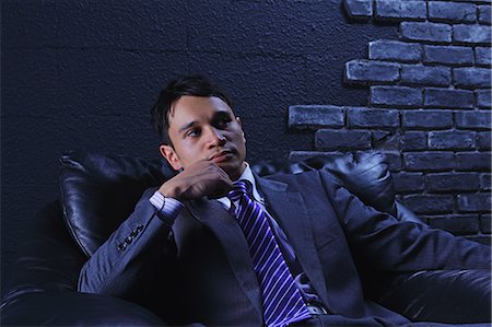 Businessman sitting on a sofa Photographie de stock - Rights-Managed, Code: 859-06537850