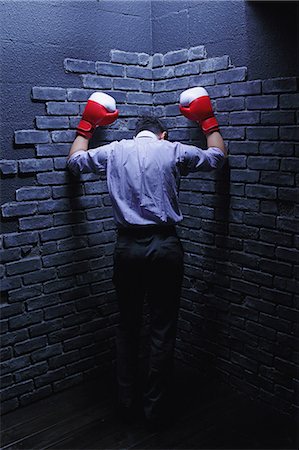 simsearch:859-06537881,k - Businessman with boxing gloves against a wall Foto de stock - Con derechos protegidos, Código: 859-06537877