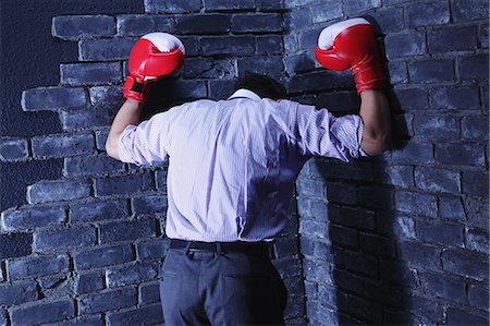 simsearch:859-06537881,k - Businessman with boxing gloves against a wall Foto de stock - Con derechos protegidos, Código: 859-06537883