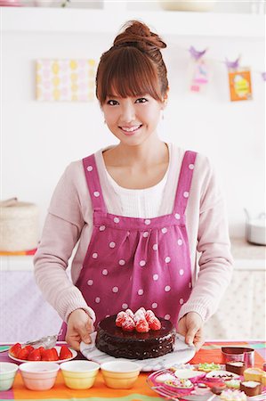 Young woman with cake in a kitchen Stock Photo - Rights-Managed, Code: 859-06538007