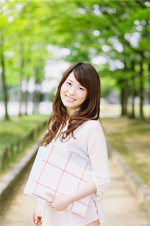 portraits of japanese women - Young woman smiling at camera Stock Photo - Rights-Managed, Code: 859-06538058