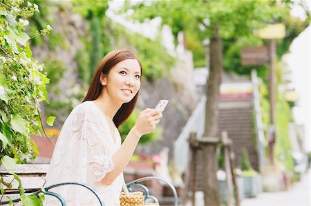 people sitting in corners - Young woman with Smartphone Stock Photo - Rights-Managed, Code: 859-06538081