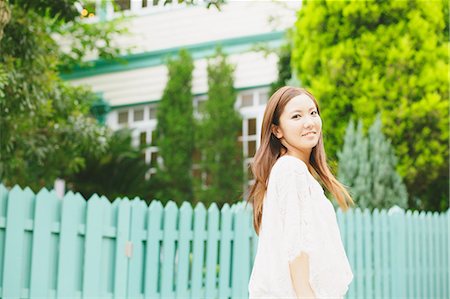 racing fences - Young woman smiling at camera Stock Photo - Rights-Managed, Code: 859-06538083