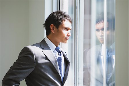 Businessman looking out of the window Stock Photo - Rights-Managed, Code: 859-06538181