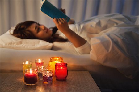 Young woman reading in bed Stock Photo - Rights-Managed, Code: 859-06538404