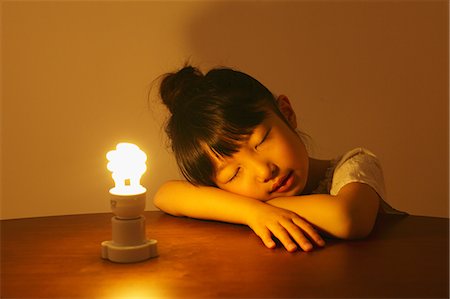 saving electricity - Girl Sleeping Near a Light Stock Photo - Rights-Managed, Code: 859-06617245