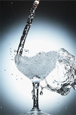 Glass full water overflowing Stock Photos - Page 1 : Masterfile