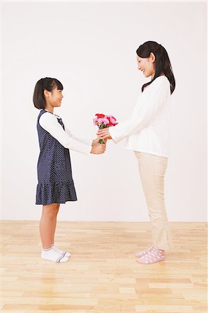 Daughter Giving Bouquet To Her Mother Stock Photo - Rights-Managed, Code: 859-06617349