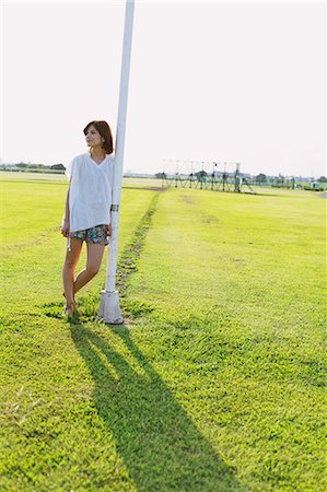 Woman Leaning On Pole Stock Photo - Rights-Managed, Code: 859-06617512