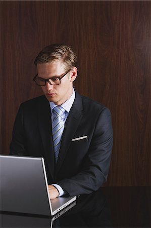 simsearch:859-06537859,k - Businessman with glasses using laptop Fotografie stock - Rights-Managed, Codice: 859-06711004