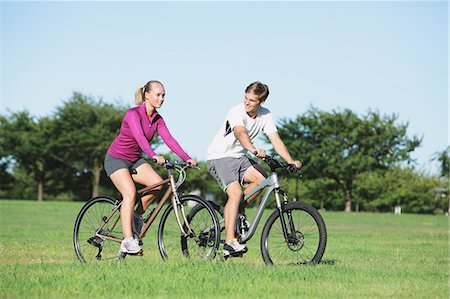 Couple riding mountain bikes in a park Stock Photo - Rights-Managed, Code: 859-06711042