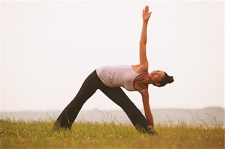 spreading - Woman practicing Yoga on grassland Stock Photo - Rights-Managed, Code: 859-06808622