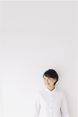 Young woman in jeans and white shirt smiling Stock Photo - Rights-Managed, Code: 859-06824631