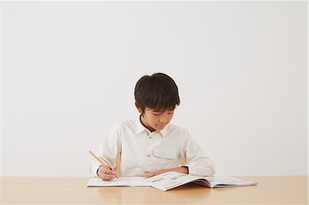 simsearch:859-07710990,k - Young boy doing his homework on wooden desk Stock Photo - Rights-Managed, Code: 859-07710976