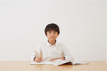 simsearch:859-07710990,k - Young boy doing his homework on wooden desk Stock Photo - Rights-Managed, Code: 859-07710977