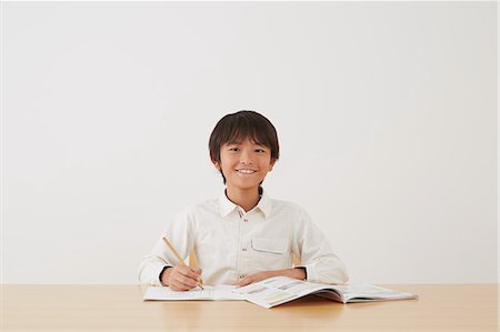 simsearch:859-07710990,k - Young boy doing his homework on wooden desk Stock Photo - Rights-Managed, Code: 859-07710978