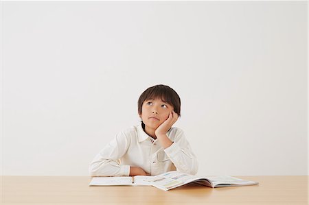 simsearch:859-07710990,k - Young boy doing his homework on wooden desk Stock Photo - Rights-Managed, Code: 859-07710980